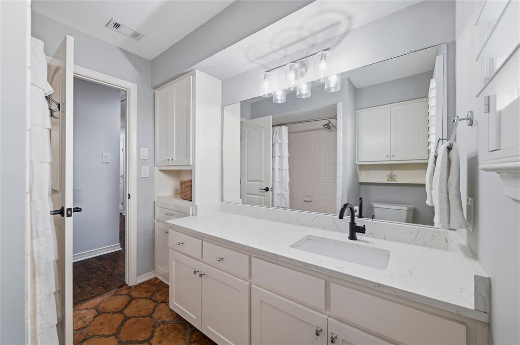 10717 Ferndale Road Dallas, TX 75238 - Photo 23 of 36 a bathroom with a sink and mirror