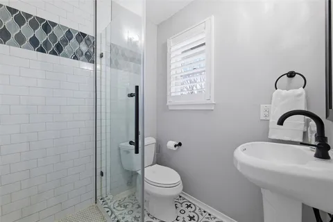 a bathroom with a sink a toilet and a shower