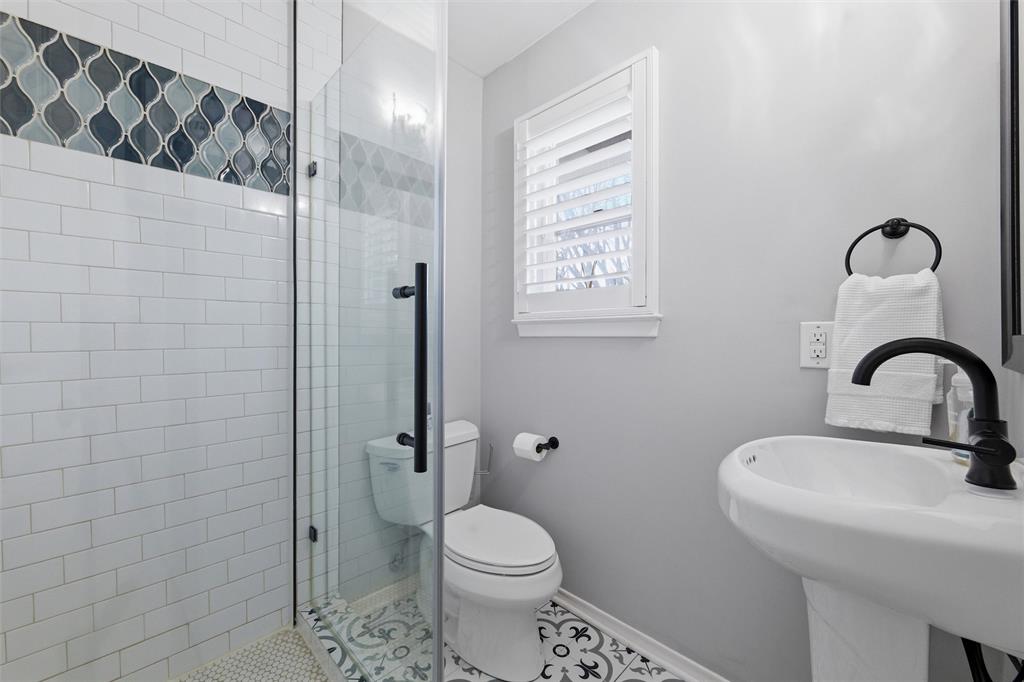 10717 Ferndale Road Dallas, TX 75238 - Photo 26 of 36 a bathroom with a sink a toilet and a shower