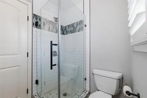 a bathroom with a shower toilet and sink