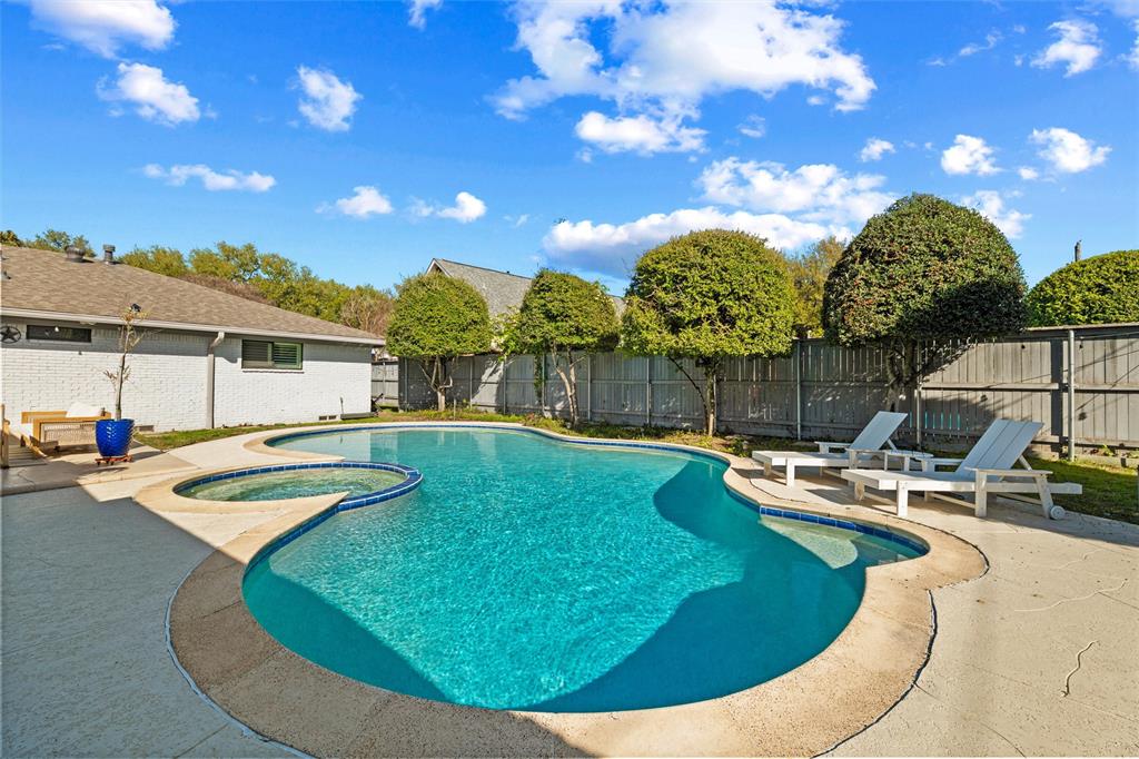 10717 Ferndale Road Dallas, TX 75238 - Photo 33 of 36 a view of a swimming pool with a yard and seating area