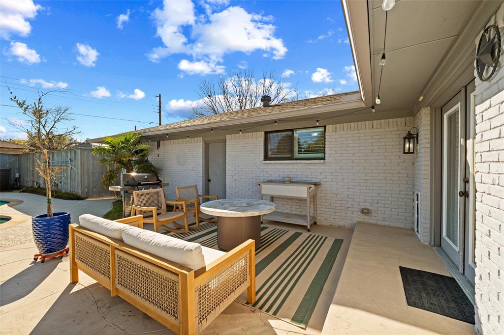 10717 Ferndale Road Dallas, TX 75238 - Photo 34 of 36 a view of a patio with couches table and chairs with wooden floor