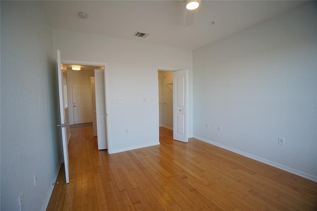 5000 Culbreath Key Way, Unit 8214 Tampa, FL 33611 - Photo 13 of 16 an empty room with wooden floor and windows