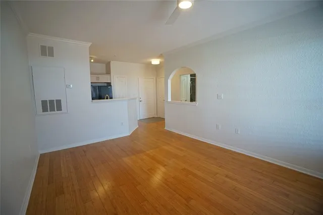 a view of empty room with wooden floor