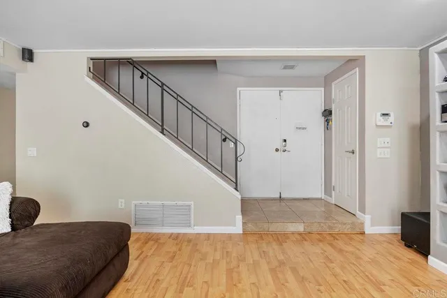 a view of a livingroom with wooden floor and stairs