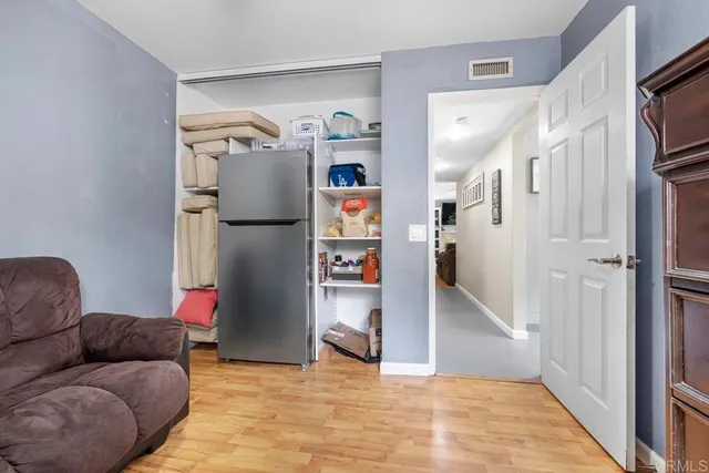 a living room with furniture and a walk in closet