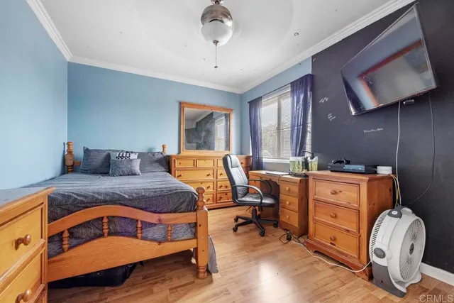 a bedroom with a bed and wooden furniture