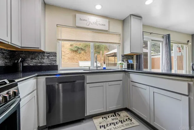 a kitchen with a sink stove and cabinets