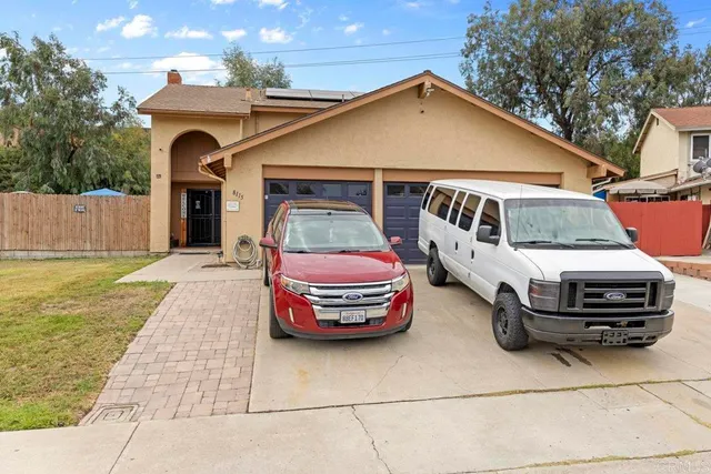 a front view of a house with parking space