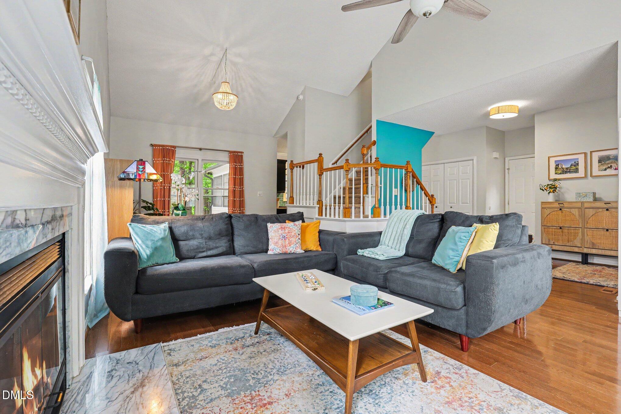 5468 Ingate Way Raleigh, NC 27613 - Photo 10 of 24 a living room with furniture a fireplace and a flat screen tv