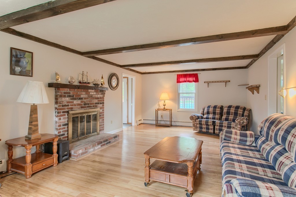 86 Squannacook Road Shirley, MA 01464 - Photo 13 of 30 a living room with furniture a fireplace and a flat screen tv