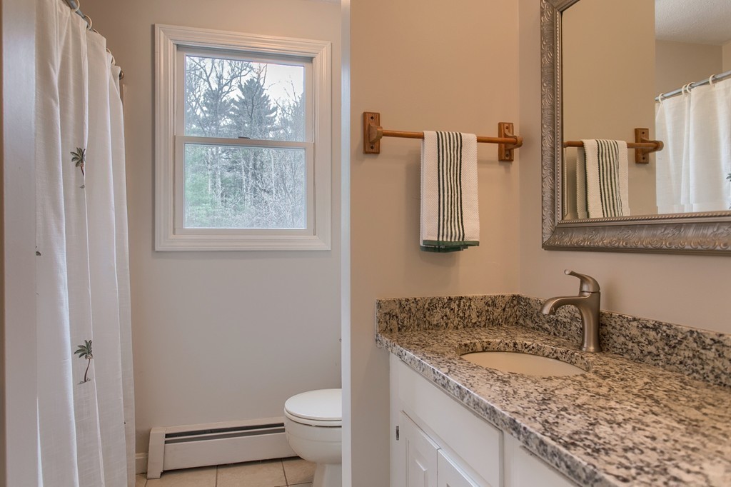 86 Squannacook Road Shirley, MA 01464 - Photo 23 of 30 a bathroom with a granite countertop sink toilet and mirror