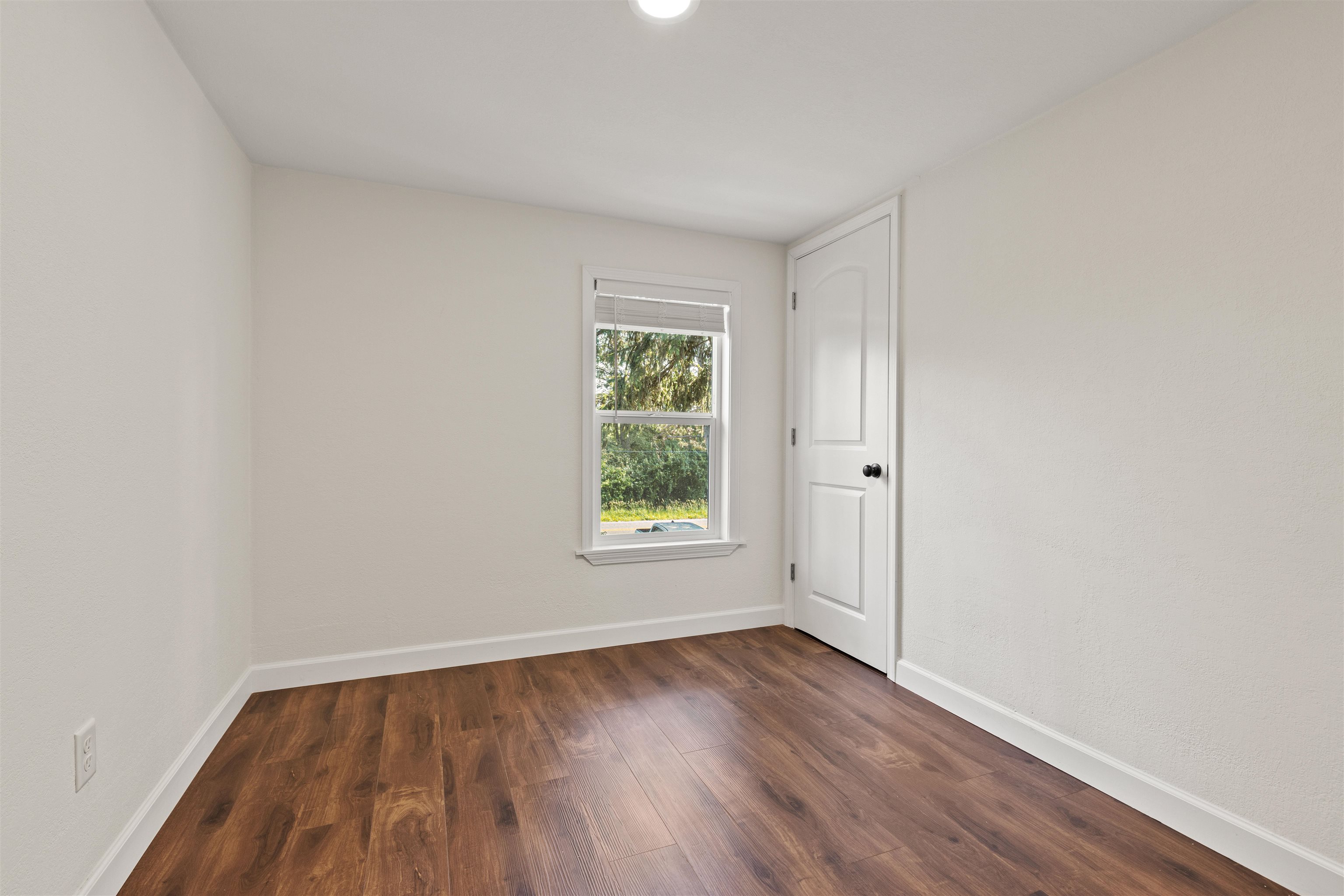 7330 Olde Creek Road Rockford, IL 61114 - Photo 14 of 20 a view of an empty room with wooden floor and a window
