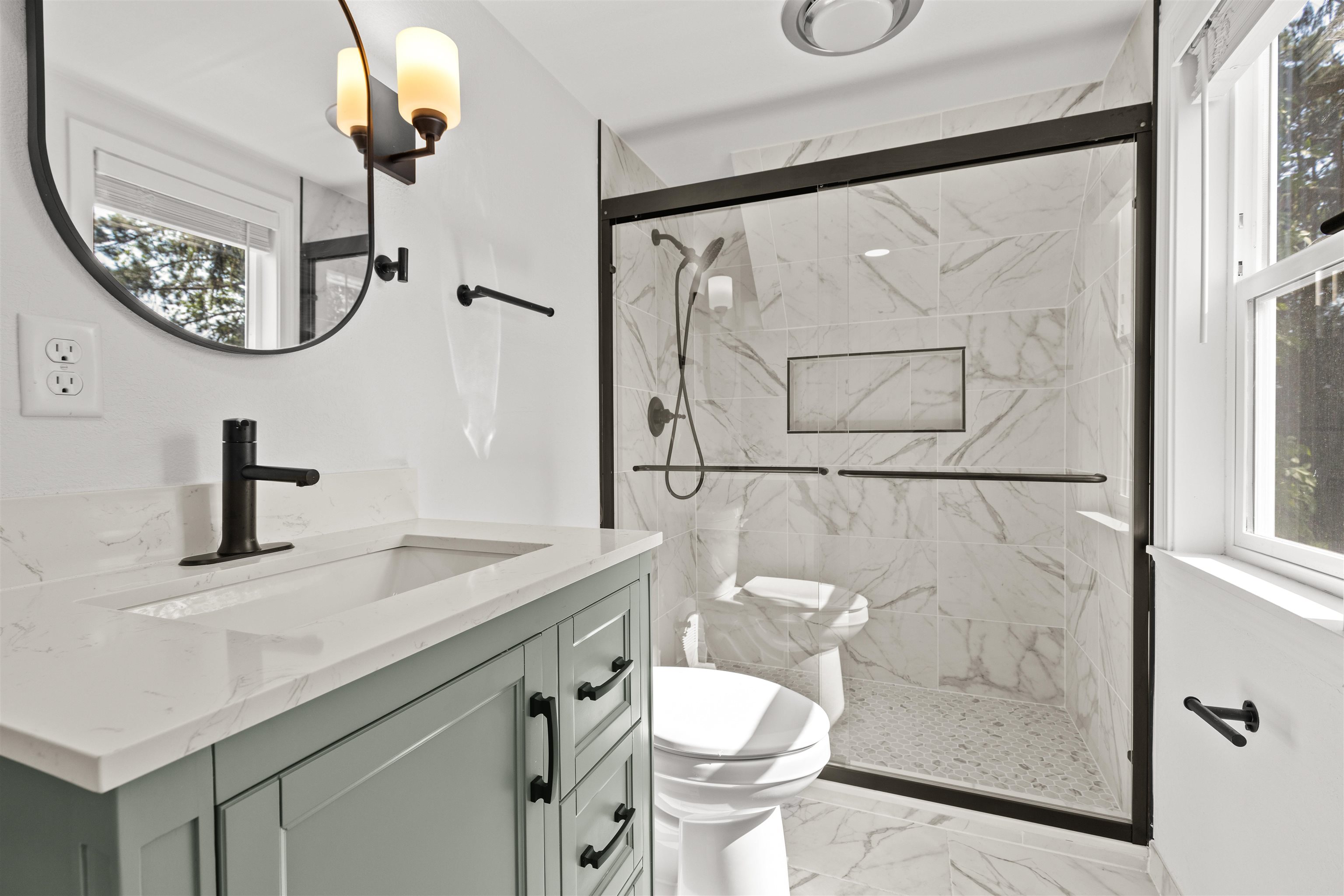 7330 Olde Creek Road Rockford, IL 61114 - Photo 15 of 20 a bathroom with a toilet a sink and mirror