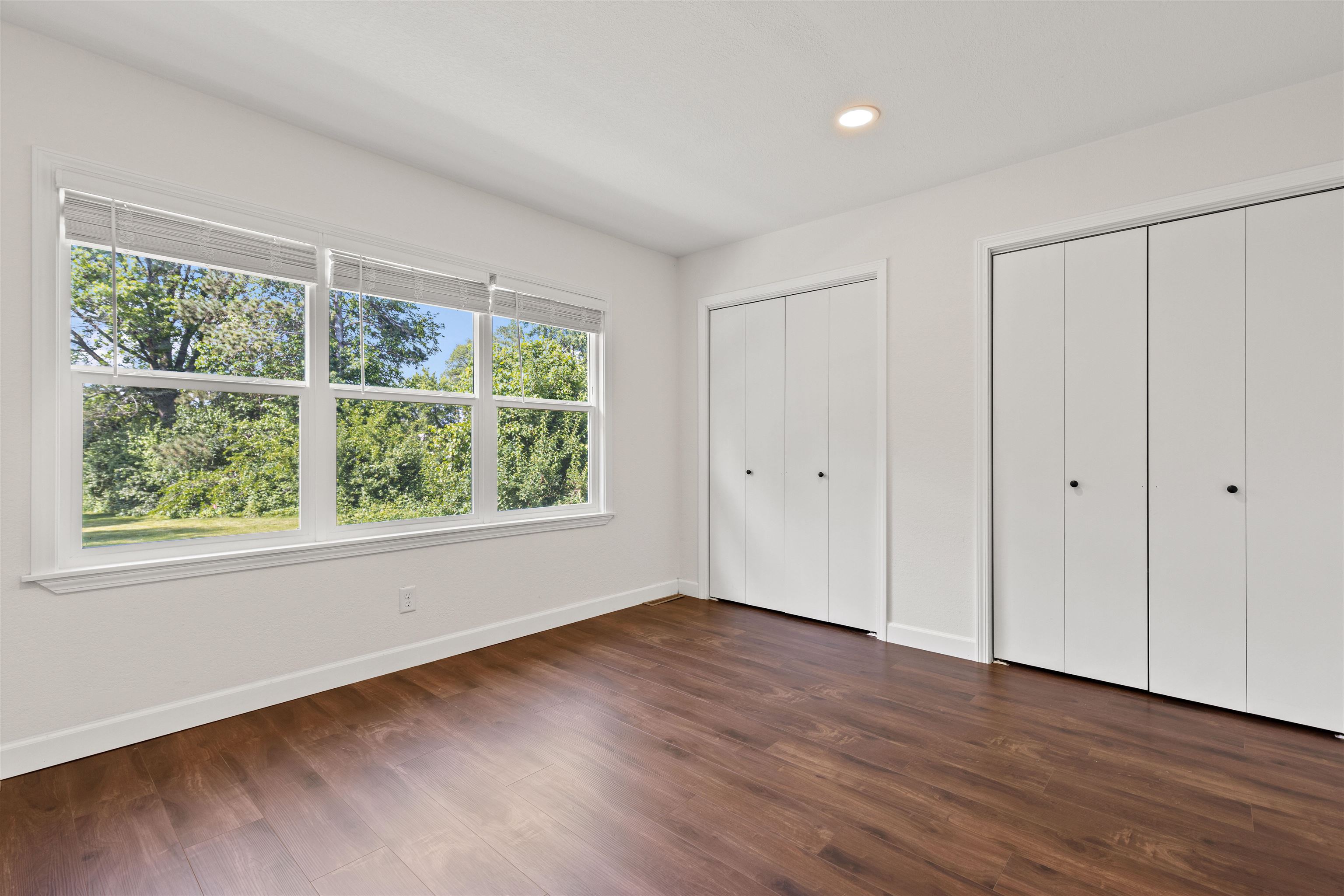 7330 Olde Creek Road Rockford, IL 61114 - Photo 16 of 20 a view of an empty room with wooden floor and a window