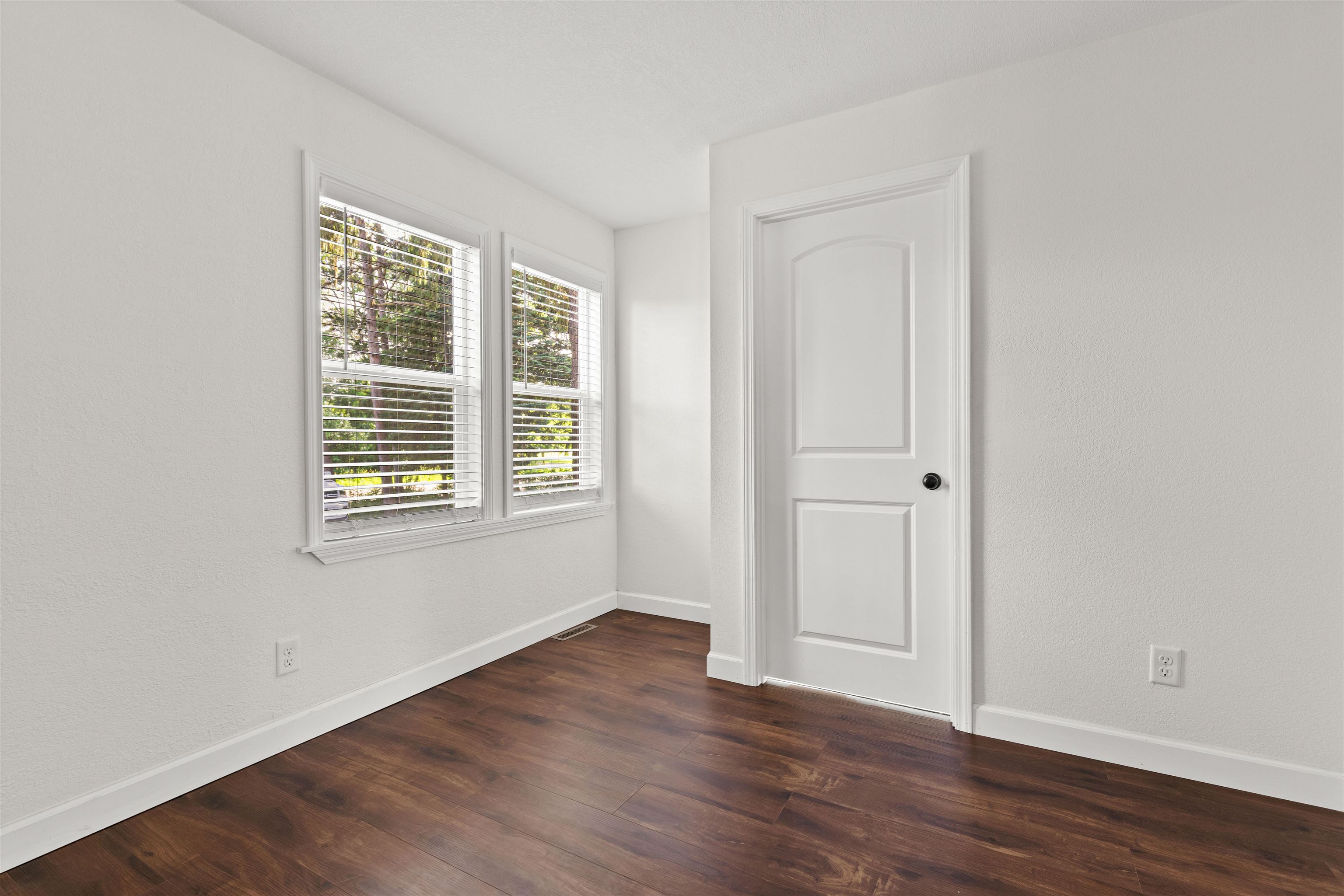 7330 Olde Creek Road Rockford, IL 61114 - Photo 17 of 20 a view of an empty room with wooden floor and a window