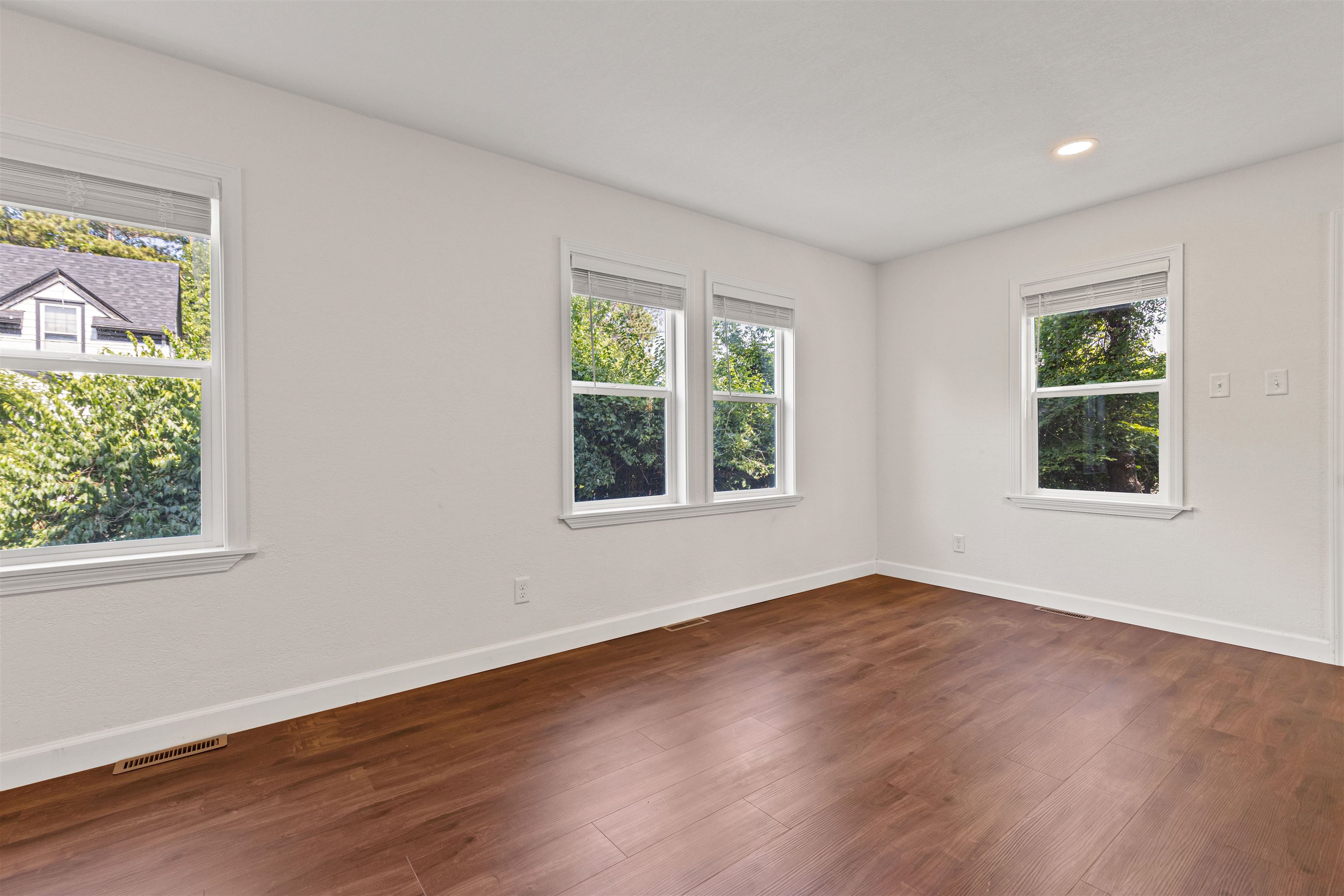 7330 Olde Creek Road Rockford, IL 61114 - Photo 3 of 20 a view of an empty room with wooden floor and windows