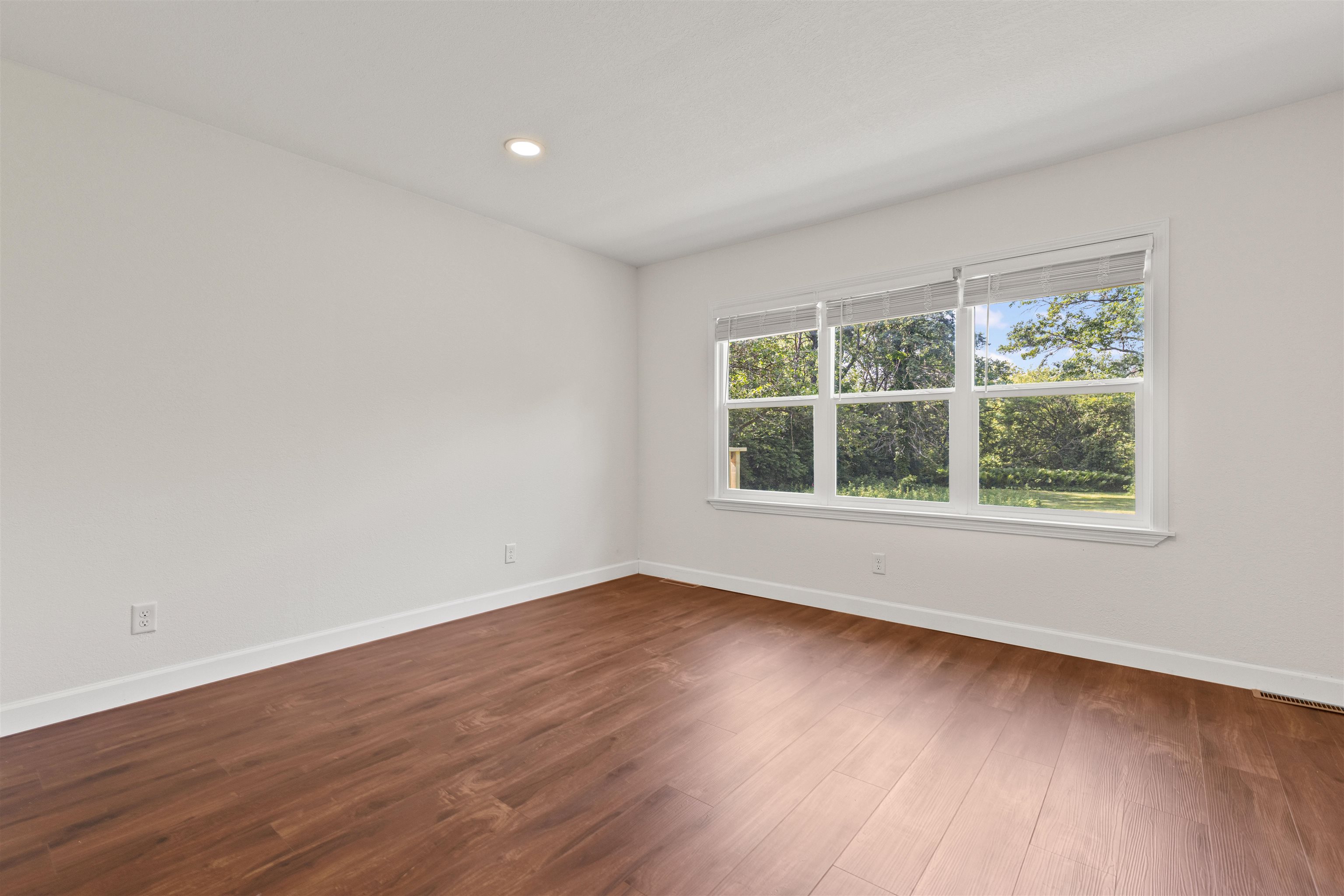 7330 Olde Creek Road Rockford, IL 61114 - Photo 4 of 20 a view of an empty room with wooden floor and a window