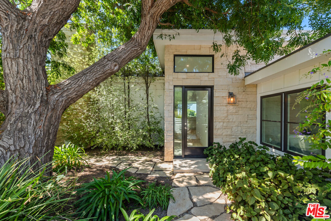 30060 Harvester Road Malibu, CA 90265 - Photo 1 of 1 a front view of a house with a yard