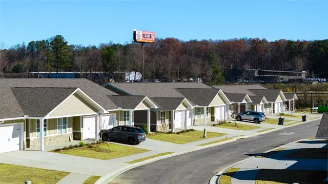 a view of multiple houses with a big yard