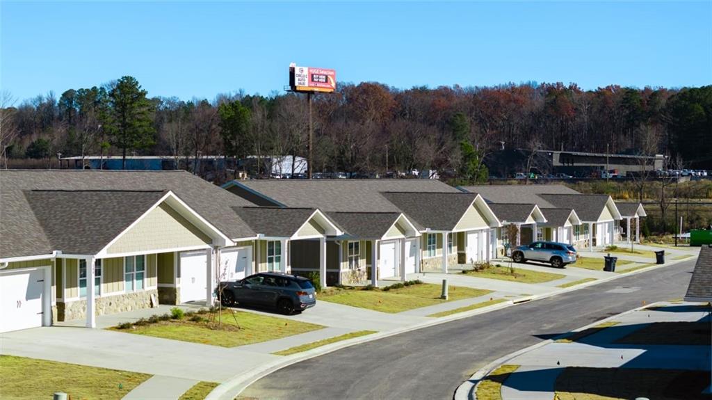 a view of multiple houses with a big yard