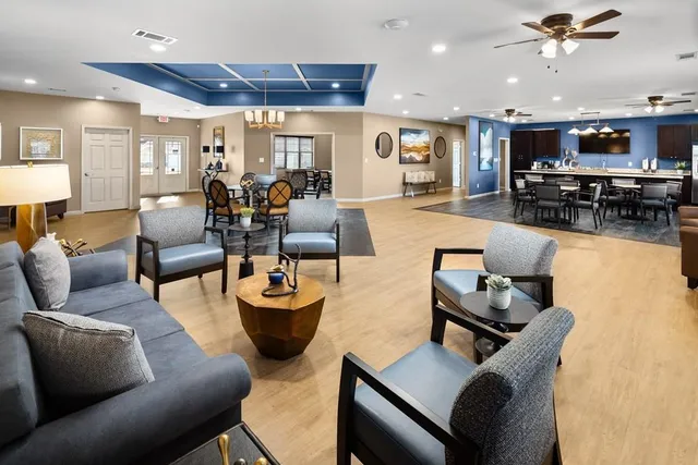 a living room with furniture and kitchen view