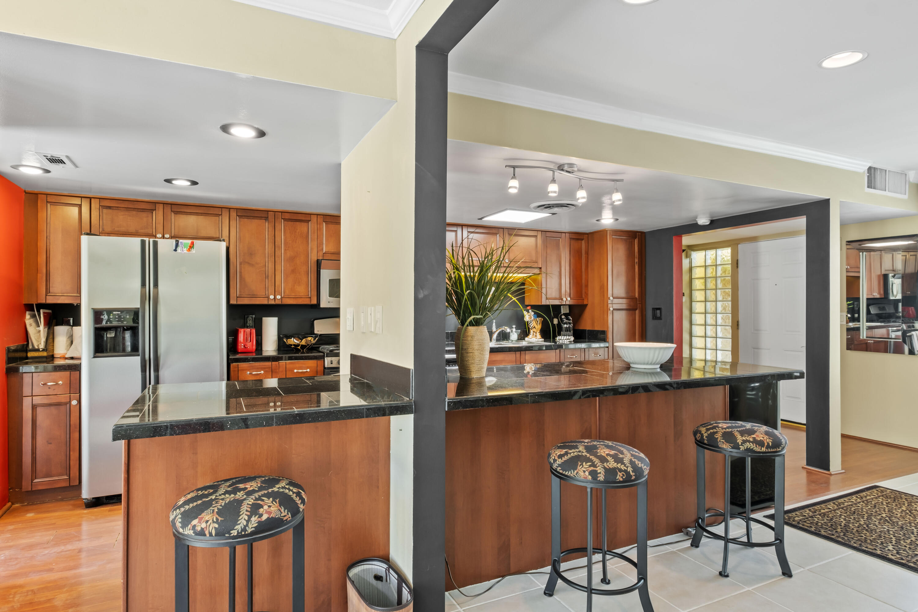 74460 Fairway Drive Palm Desert, CA 92260 - Photo 12 of 36 a kitchen with stainless steel appliances granite countertop a refrigerator a stove and a sink with wooden floor