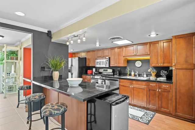 a kitchen with granite countertop a sink and cabinets