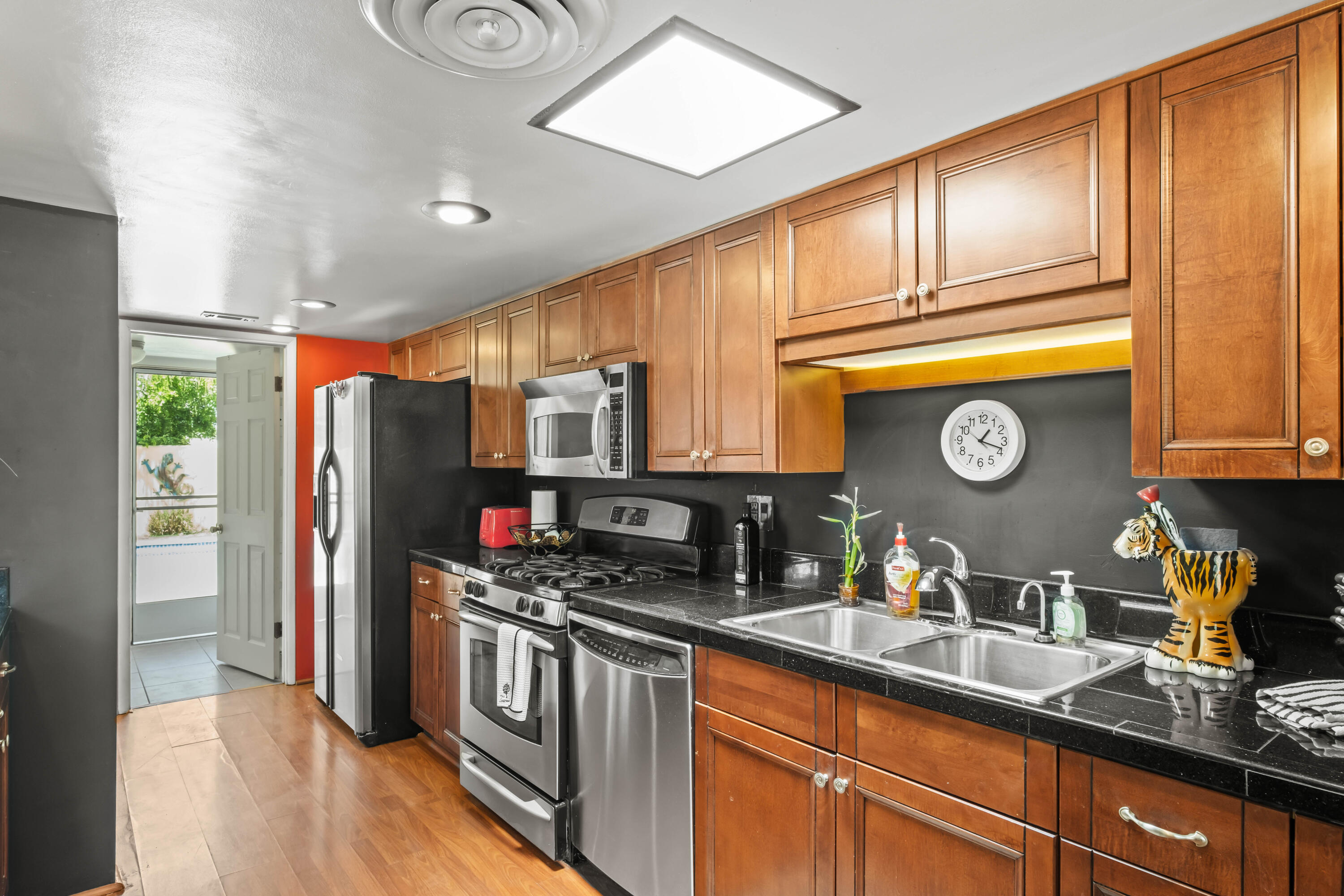 74460 Fairway Drive Palm Desert, CA 92260 - Photo 14 of 36 a kitchen with stainless steel appliances granite countertop a refrigerator a stove and wooden cabinets