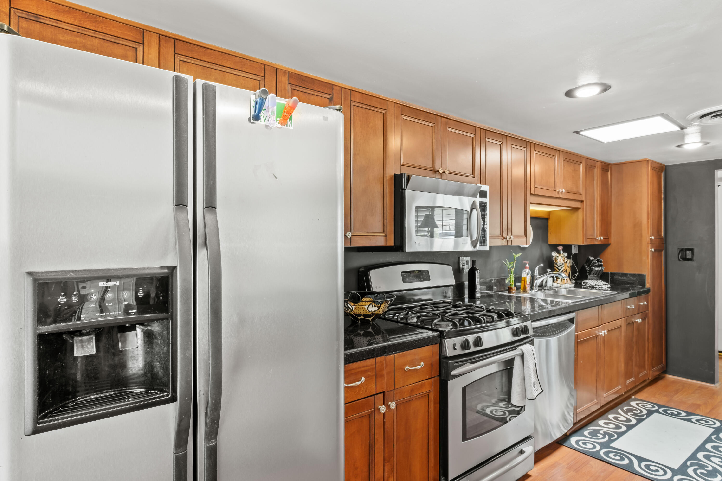 74460 Fairway Drive Palm Desert, CA 92260 - Photo 15 of 36 a kitchen with stainless steel appliances granite countertop a stove a sink and a refrigerator