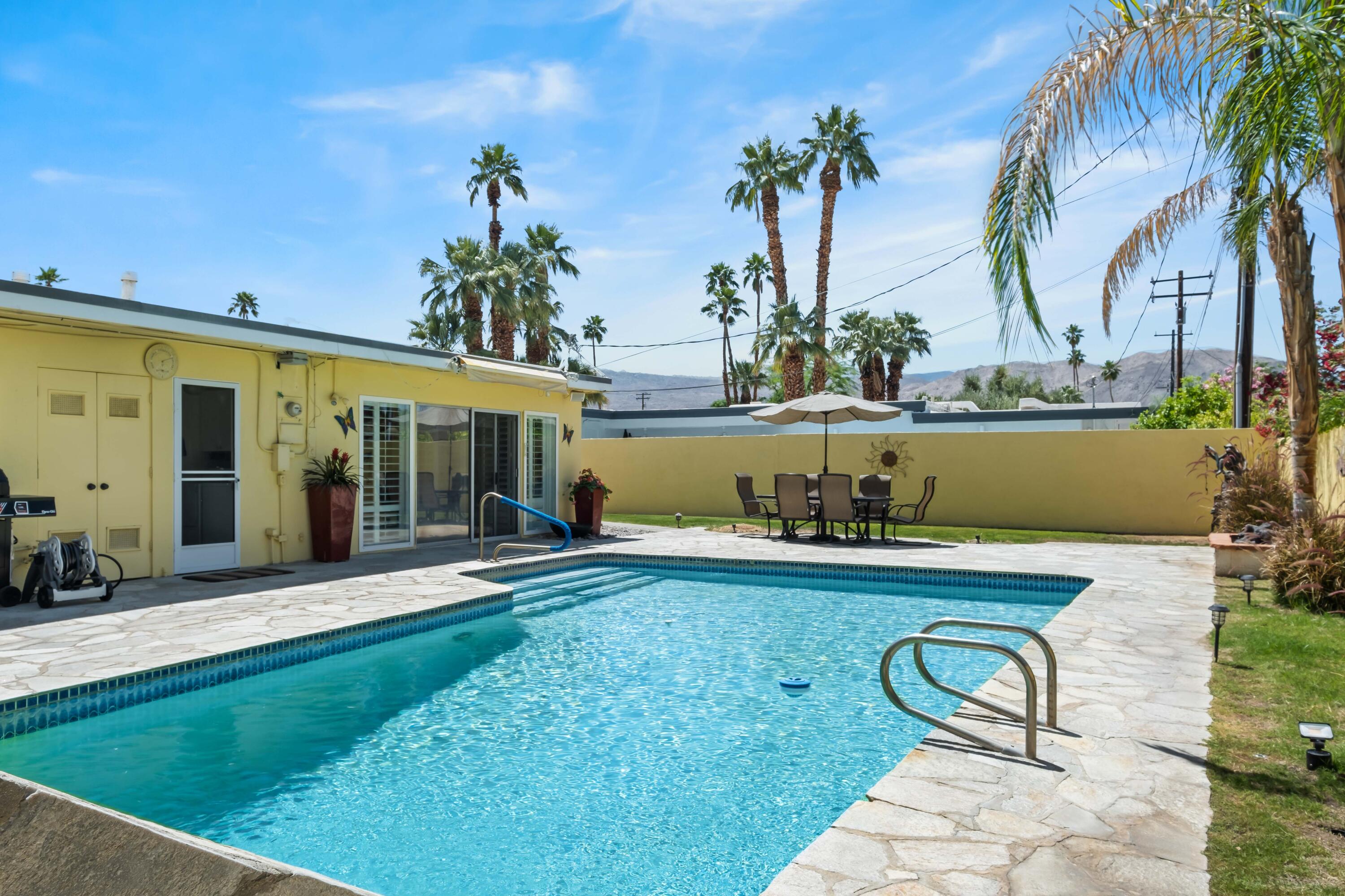 74460 Fairway Drive Palm Desert, CA 92260 - Photo 2 of 36 a view of a house with backyard and sitting area