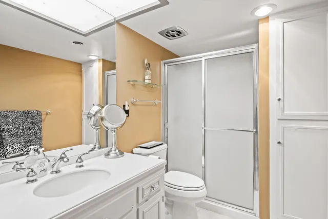 a bathroom with a sink toilet and shower