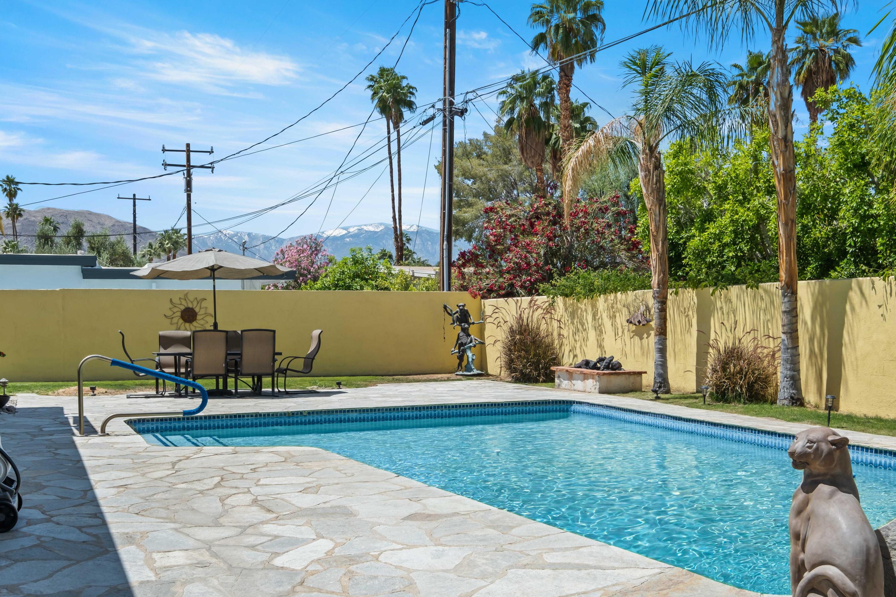 74460 Fairway Drive Palm Desert, CA 92260 - Photo 29 of 36 a view of a lake with couches and wooden floor