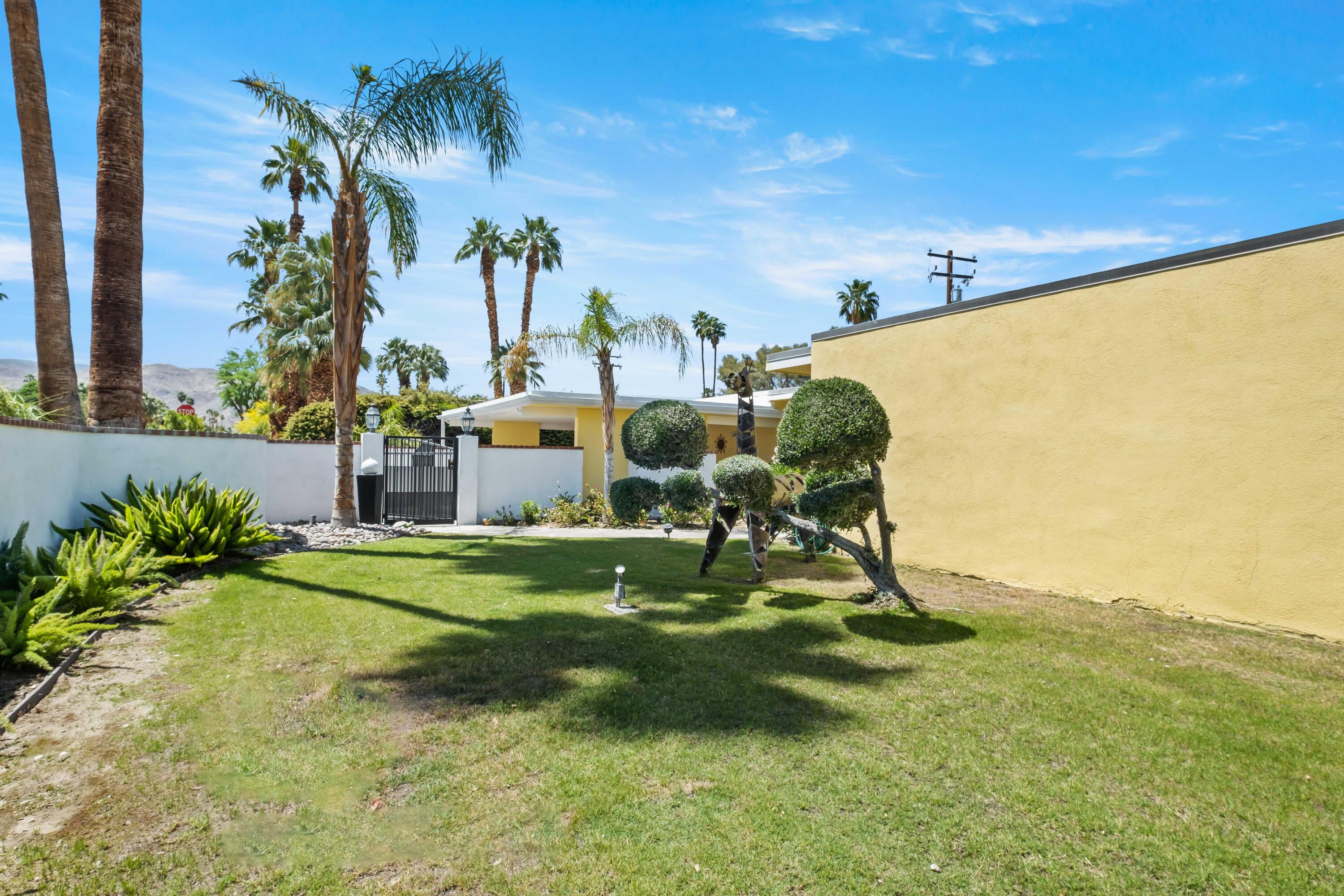 74460 Fairway Drive Palm Desert, CA 92260 - Photo 32 of 36 a backyard of a house with table and chairs