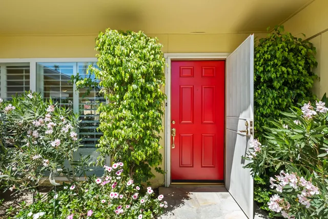 front view of a house with a red gate