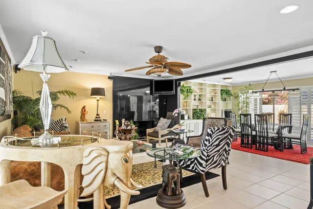 a dining room with furniture water view and a floor to ceiling window