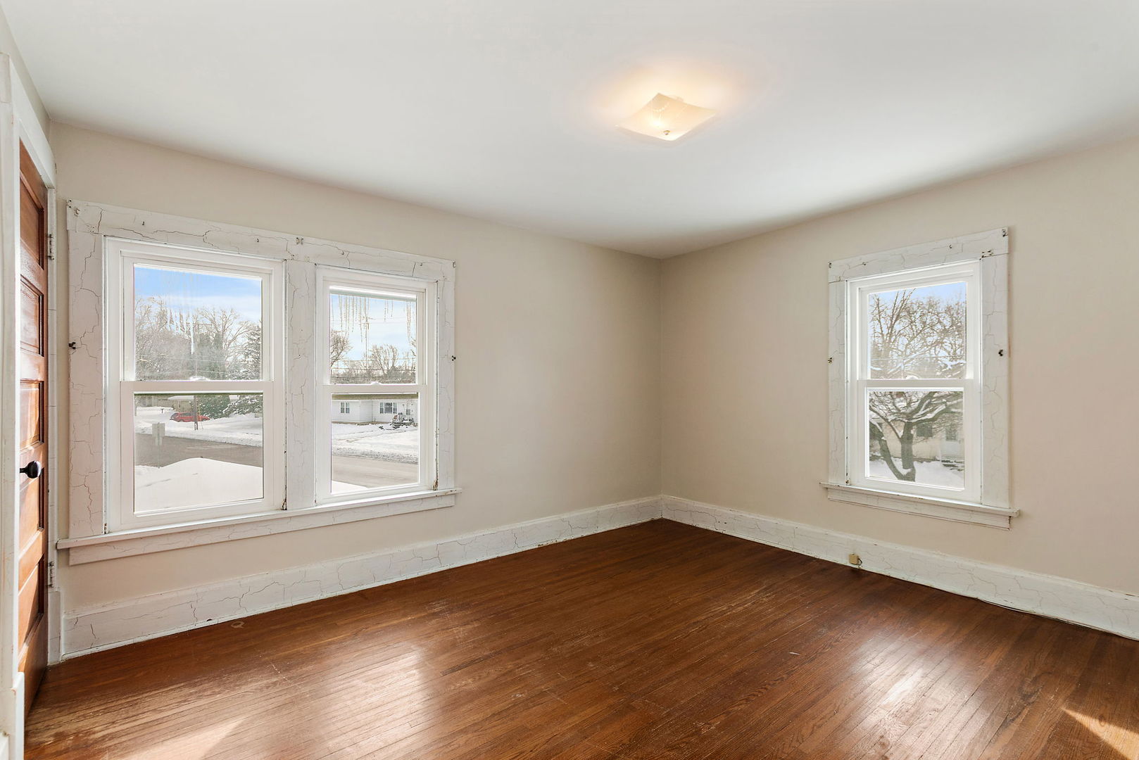 844 South 1st Street DeKalb, IL 60115 - Photo 15 of 26 a view of an empty room with wooden floor and a window