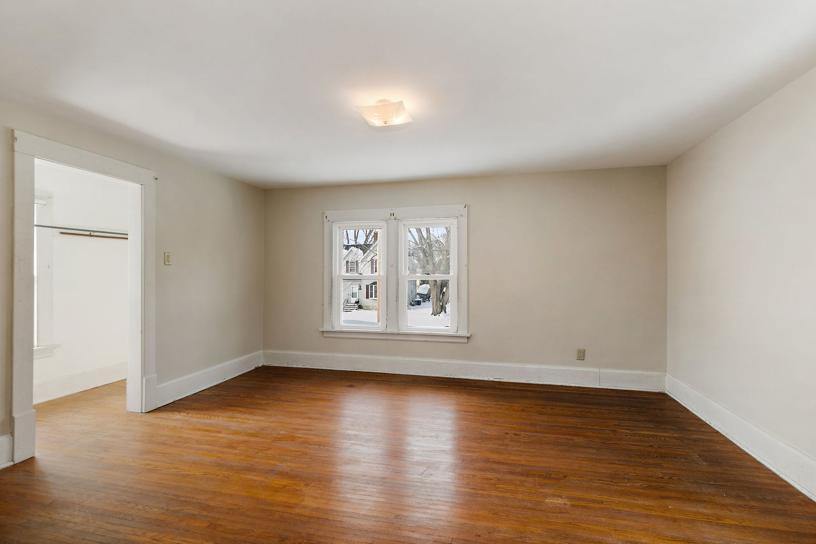 844 South 1st Street DeKalb, IL 60115 - Photo 18 of 26 an empty room with wooden floor and windows