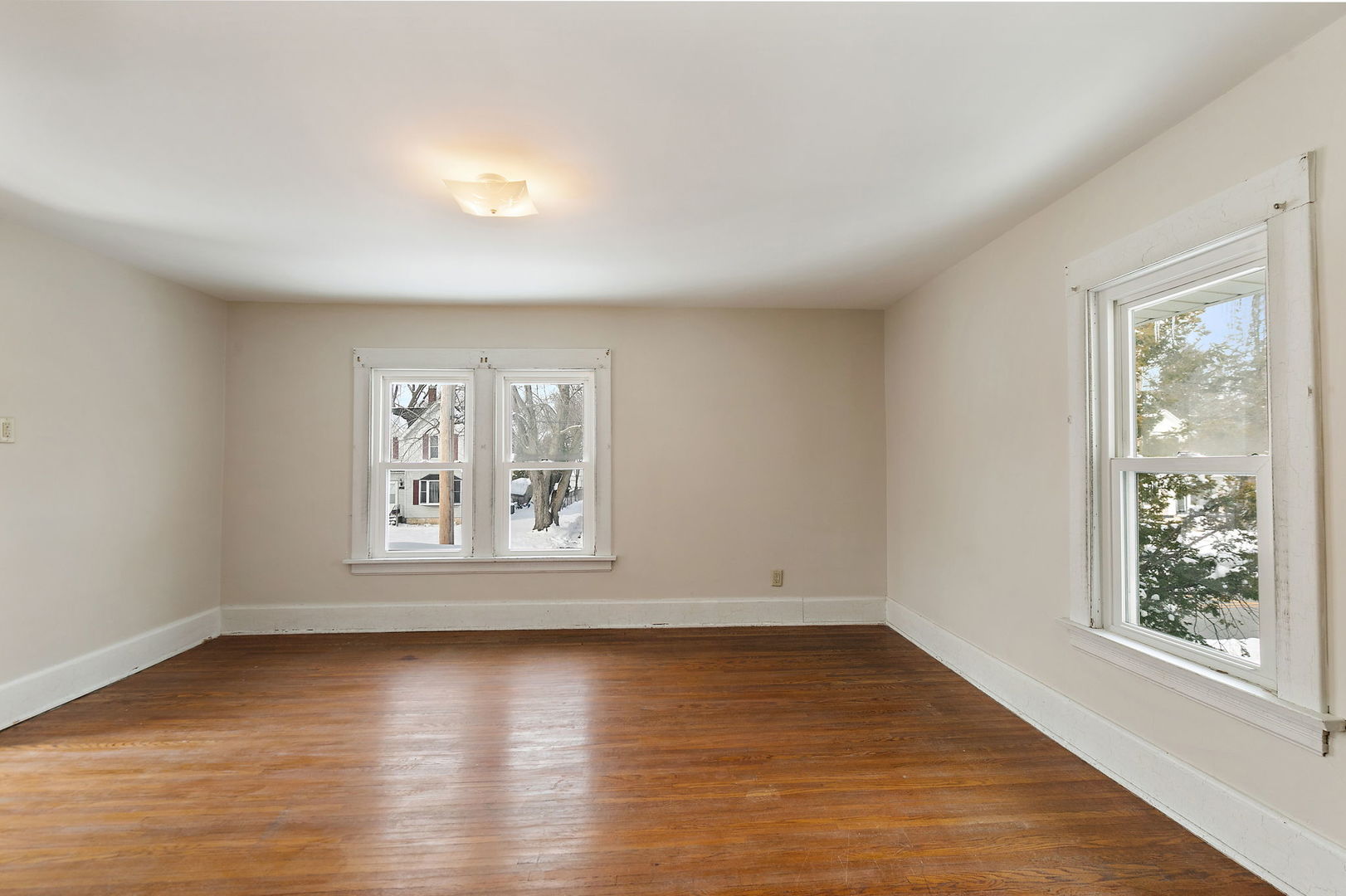 844 South 1st Street DeKalb, IL 60115 - Photo 20 of 26 an empty room with wooden floor and windows