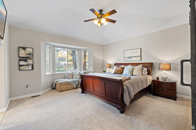 6208 West Bull River Road Highland, UT 84003 - Photo 32 of 90 Carpeted bedroom featuring a bay window with a built-in window seat, a ceiling fan with integrated lighting, and neutral wall tones