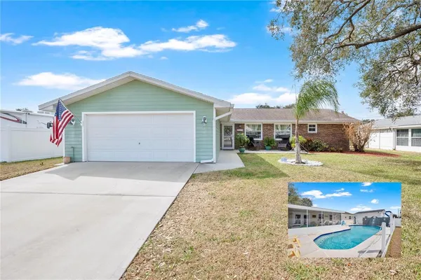 a view of a house with a yard and garage
