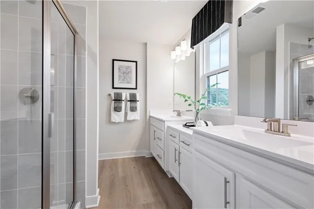 a bathroom with double sink and a mirror