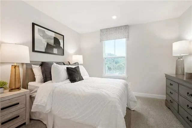 a bedroom with bed and window