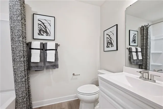 a bathroom with a toilet a sink and a large mirror