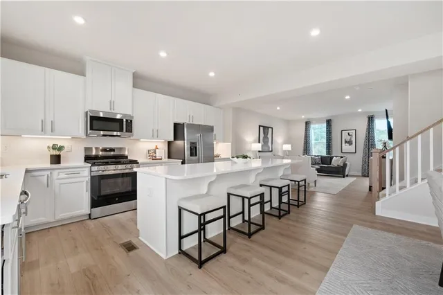 a kitchen with cabinets a sink and appliances