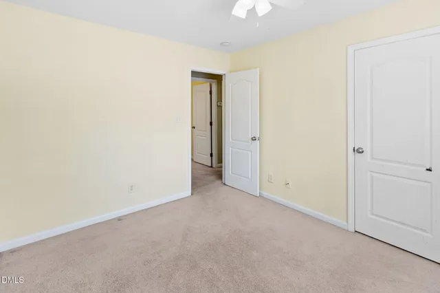 an empty room with a ceiling fan