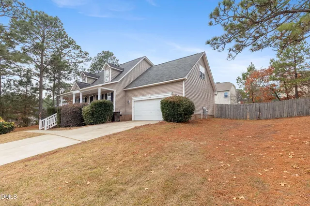 a view of a house with a yard and garage