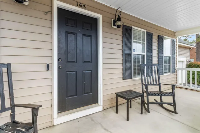 a view of a porch with a table and chairs