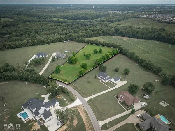 an aerial view of a house with a lake view