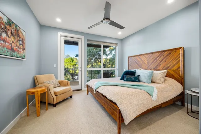 a bedroom with a large bed and a chandelier